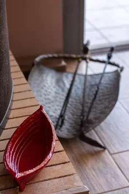 a red bowl on a table next to a basket at Serenity Villa-Ground floor-Sea view- sea 150m away in Porto Rafti