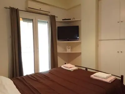 a bedroom with a bed with two towels on it at Athens Home 2 in Athens