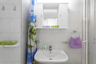 a white bathroom with a sink and a mirror at Athens Home 2 in Athens