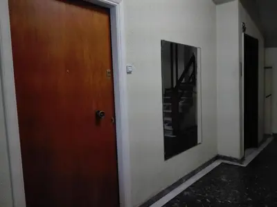 a wooden door in a hallway with a staircase at Athens Home 2 in Athens