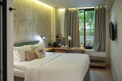 a bedroom with a bed and a desk and a window at COCO-MAT Athens Jumelle in Athens