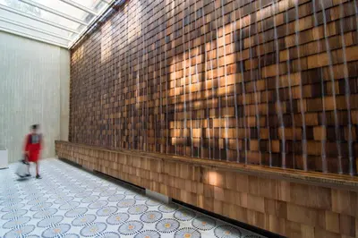 a person walking down a hallway in a building at COCO-MAT Athens Jumelle in Athens