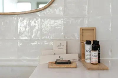a bathroom counter with two boxes of products and a mirror at COCO-MAT Athens Jumelle in Athens