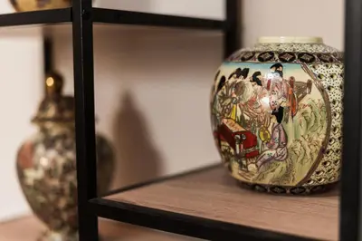a vase sitting on top of a wooden shelf at Alimos Apartment in Athens