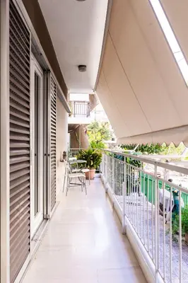 a balcony of a house with a view of the yard at Alimos Apartment in Athens