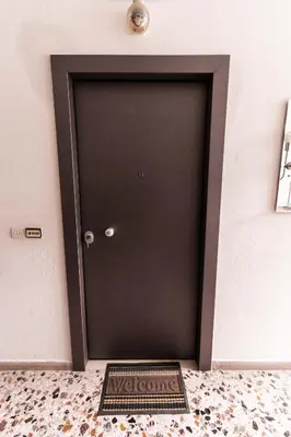 a black door with a welcome sign in front of it at Alimos Apartment in Athens