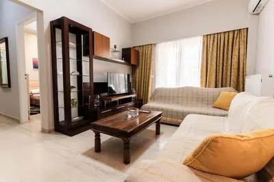 a living room with a couch and a coffee table at Alimos Apartment in Athens