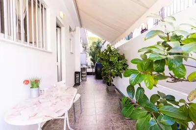 a balcony with two tables and potted plants at Alimos Apartment in Athens
