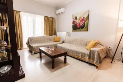 a living room with a couch and a coffee table at Alimos Apartment in Athens