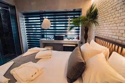 a bedroom with a large white bed with pillows at Project 3 Urban Chic Hotel in Athens