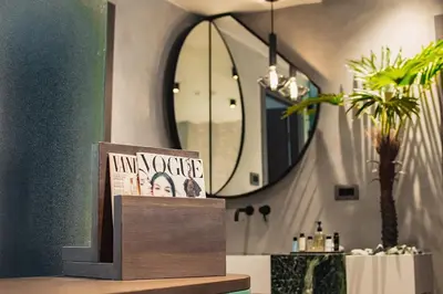 a book sitting on a table in front of a mirror at Project 3 Urban Chic Hotel in Athens