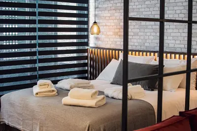 a bedroom with a bed with towels on it at Project 3 Urban Chic Hotel in Athens