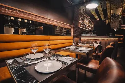 a restaurant with two tables with wine glasses at Project 3 Urban Chic Hotel in Athens