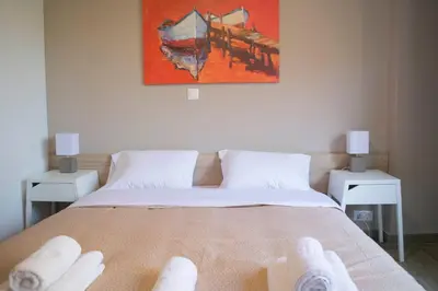 a bedroom with a bed with white towels on it at Chic and Minimal apartment close to Thissio Metro in Athens