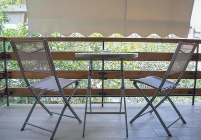 two chairs and a table on a patio at Chic and Minimal apartment close to Thissio Metro in Athens