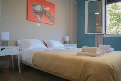 a bedroom with a bed with two towels on it at Chic and Minimal apartment close to Thissio Metro in Athens