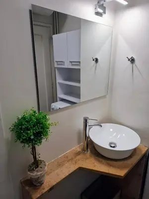 a bathroom with a sink and a mirror at Studio Posh with garden in Kolonaki in Athens
