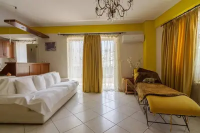 a living room with a white couch and yellow walls at Nea Smirni Luxury Apartment in Athens