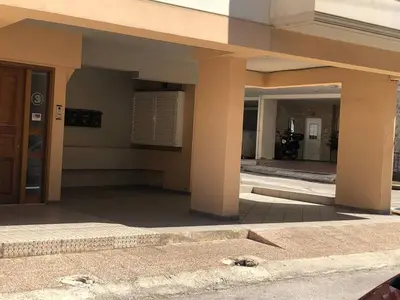 a building with a dog laying on the ground at Nea Smirni Luxury Apartment in Athens