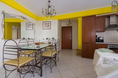 a kitchen and dining room with a table and chairs at Nea Smirni Luxury Apartment in Athens