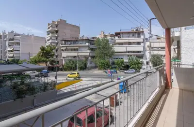 a balcony with a train on a city street at Nea Smirni Luxury Apartment in Athens