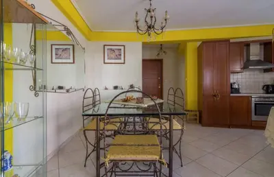 a kitchen with a table and chairs in a room at Nea Smirni Luxury Apartment in Athens