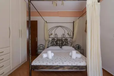 a bedroom with a canopy bed with two pillows at Nea Smirni Luxury Apartment in Athens
