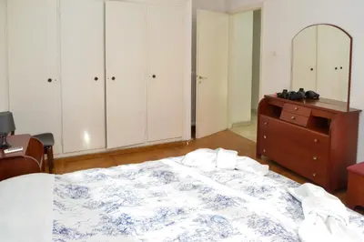 a bedroom with a bed and a dresser and a mirror at Acropolis amazing balcony view 3 minutes walking to the museum in Athens