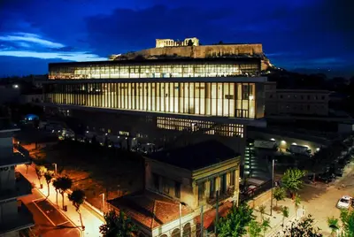 a large building in a city at night at Acropolis amazing balcony view 3 minutes walking to the museum in Athens