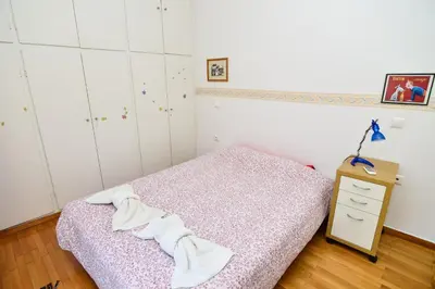 a bedroom with a bed and a dresser with towels at Acropolis area 5 minutes to the Museum and metro in Athens