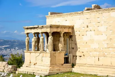 a stone building with pillars on the side at Acropolis area 5 minutes to the Museum and metro in Athens