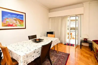 a dining room with a white table and chairs at Acropolis area 5 minutes to the Museum and metro in Athens