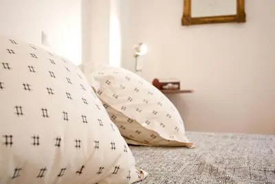two pillows sitting on a bed in a bedroom at Acropolis area 5 minutes to the Museum and metro in Athens