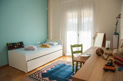 a childs bedroom with a bed and a table at 2 BEDROOM APARTMENT AT THE HISTORICAL CENTER, VIEW TO ACROPOLIS in Athens
