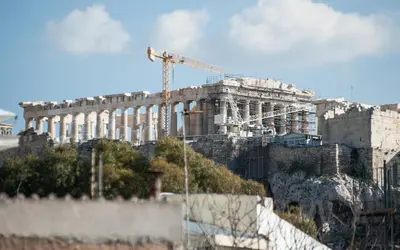 a building under construction on top of a mountain at 2 BEDROOM APARTMENT AT THE HISTORICAL CENTER, VIEW TO ACROPOLIS in Athens