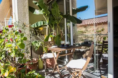 a patio with a table and chairs and plants at 2 BEDROOM APARTMENT AT THE HISTORICAL CENTER, VIEW TO ACROPOLIS in Athens