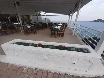 a restaurant on a boat with a table and chairs at Hotel 3 Adelfia in Agia Marina Aegina
