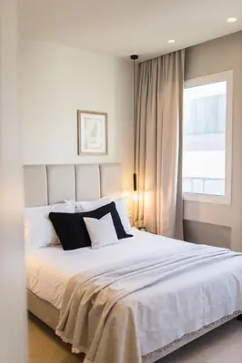 a bedroom with a large white bed with a window at Luxury Apartments in Plaka by UPSTREET in Athens