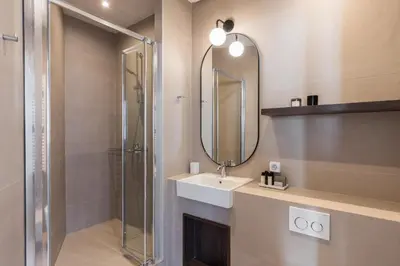 a bathroom with a shower and a sink and a mirror at Luxury Apartments in Plaka by UPSTREET in Athens