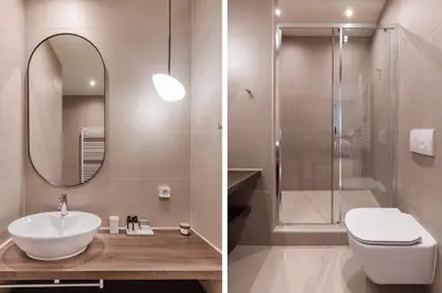 a bathroom with a sink and a toilet and a mirror at Luxury Apartments in Plaka by UPSTREET in Athens
