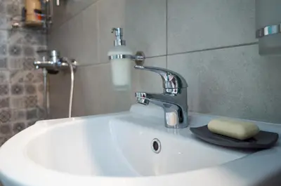 a bathroom sink with a faucet and a soap at THE HOUSE OF LAVENDER in Athens