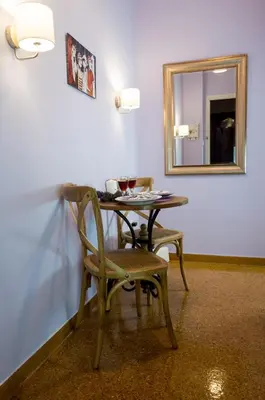 a table with a chair and a mirror in a room at THE HOUSE OF LAVENDER in Athens