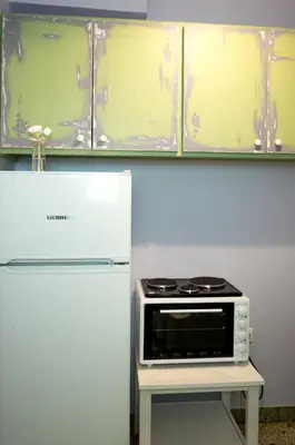 a microwave on a table next to a refrigerator at THE HOUSE OF LAVENDER in Athens