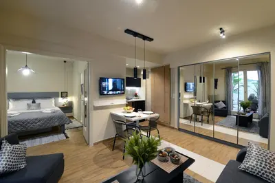 a bedroom and living room with a bed and a table at Amazing apartment in Kolonaki in Athens