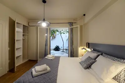 a bedroom with a bed with a view of the ocean at Amazing apartment in Kolonaki in Athens