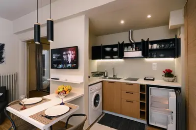 a kitchen with a table and a dining room at Amazing apartment in Kolonaki in Athens