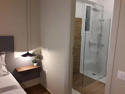 a bathroom with a shower with a glass door at Amazing apartment in Kolonaki in Athens
