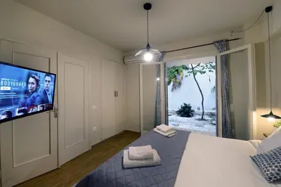 a bedroom with a bed and a flat screen tv at Amazing apartment in Kolonaki in Athens