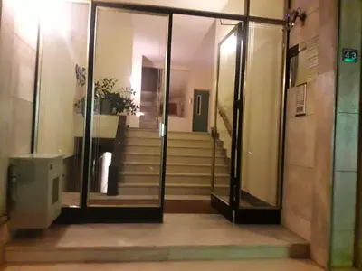 a staircase in a building with glass doors and stairs at Amazing apartment in Kolonaki in Athens