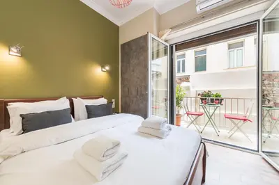two beds in a room with a balcony at Let me Athens you! #3 in Athens